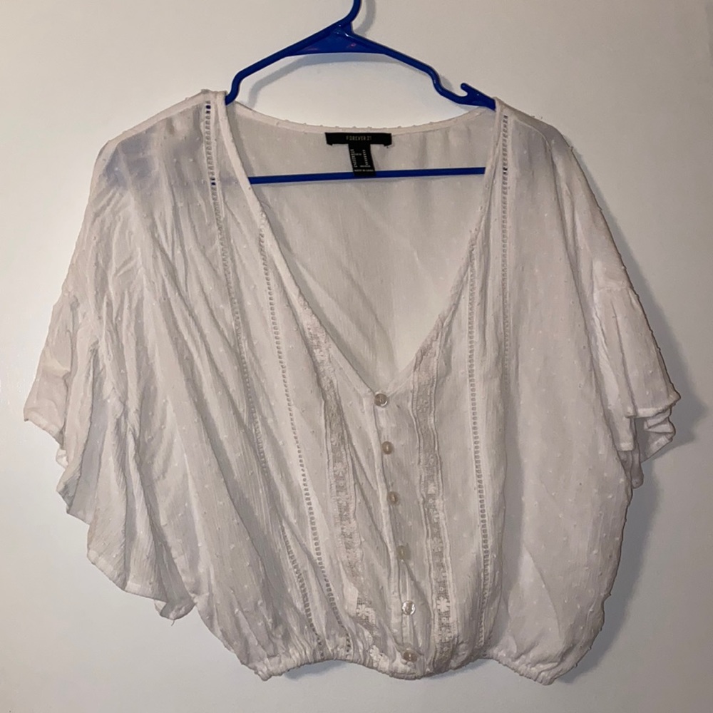 White cropped blouse with wide ruffled sleeve